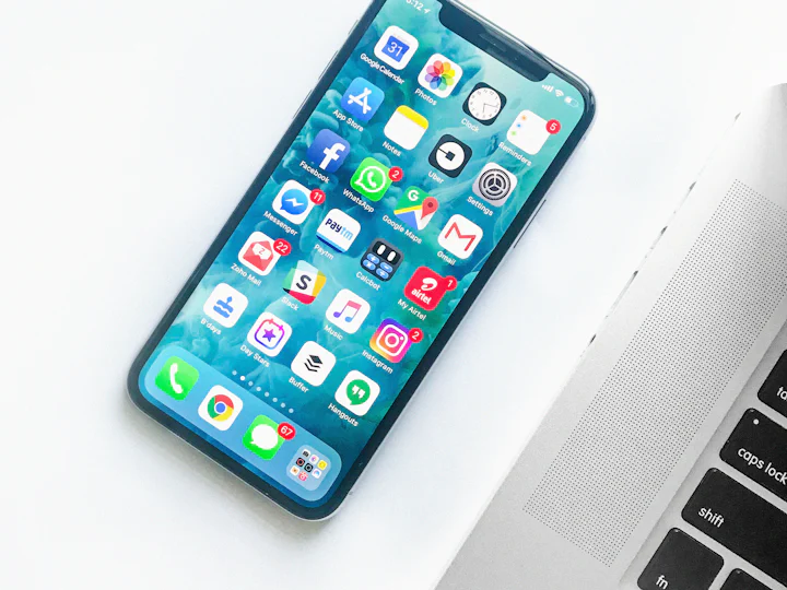 Smartphone next to a laptop